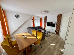 a living room with a table and a couch at Haus der Sonne in Soltau