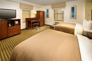 a hotel room with two beds and a flat screen tv at Comfort Inn Downtown DC/Convention Center in Washington, D.C.