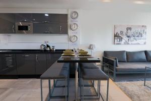 a kitchen and living room with a table and a couch at Dassine View - Luxe - Agadir - 5 Px in Agadir