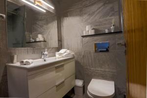 a bathroom with a white sink and a toilet at Dassine View - Luxe - Agadir - 5 Px in Agadir