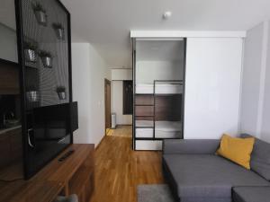 a living room with a couch and a tv at Serendipity Apartment in Brzeće