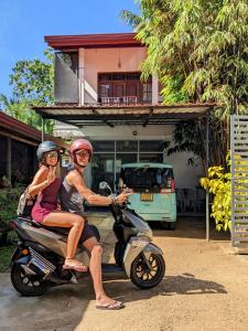 a man and woman riding on a scooter at Lavish Lodge, Tangalle, Sri Lanka in Tangalle