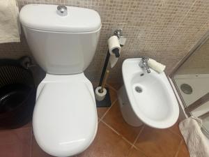 a bathroom with a white toilet and a bidet at Beira Mar AB2 in Santa Maria +21 photos