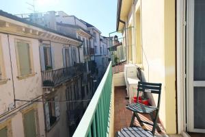 a chair sitting on the balcony of a building at Case VR Holiday - Residenza Leo in Verona