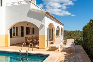 a villa with a swimming pool and a patio at Villa Cayetana by Escape Home in Mahón