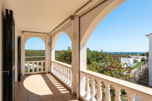 an arched balcony with a view of the ocean at Villa Cayetana in Mahón