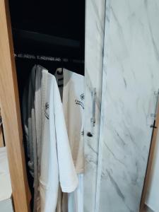 a closet with white towels and a marble counter at Chevilly Resort & Camp in Bogor