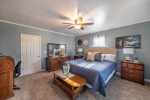 a bedroom with a bed and a ceiling fan at Maplewood Farmhouse + Hot tub in Howland Corners