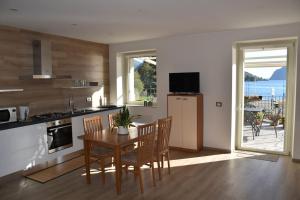 a kitchen and dining room with a table and chairs at Casa vacanze Casa Vittoria cod.017106-cni-00074 in Marone