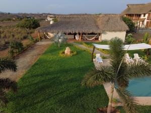 an aerial view of a house with a grass roof at Casa Carey Villa en la Playa in Tlachicón