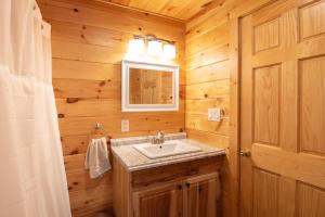 a bathroom with a sink and a mirror at Fisher Mountain Retreat 