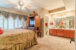 a bedroom with a bed and a bathroom with a sink at Branson Condo at Thousand Hills Walkin with Elevator Golf Front near 76 Strip in Branson