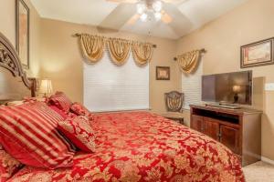 a bedroom with a large bed and a television at Branson Condo at Thousand Hills Walkin with Elevator Golf Front near 76 Strip in Branson