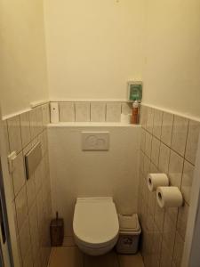 a small bathroom with a toilet and two rolls of toilet paper at Belle maison ! in Brussels