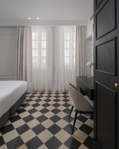 A bed or beds in a room at Boutique Hotel Cordial La Niña de Vegueta