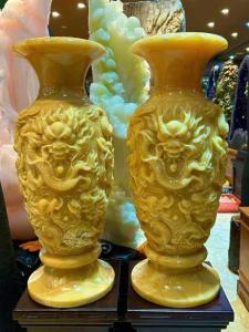 two yellow vases on a shelf in a store at Đá Quý Duyên Chiến in Tam Ðiệp