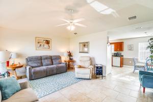 a living room with a couch and a table at Foley Getaway with Fenced Yard - 13 Mi to Beaches! in Foley
