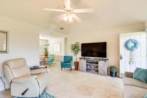 a living room with a flat screen tv and chairs at Family-Friendly Foley Getaway with Fenced Yard! in Foley