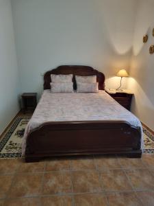a bedroom with a large bed with two pillows at Quinta Da Mata in Sobral