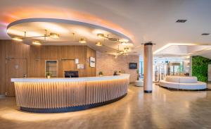 a lobby with a bar in a building at Occidental Murcia Agalia in Murcia