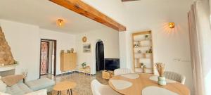 a living room with a table and a couch at Villa Sol in Moraira