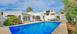 an exterior view of a house with a swimming pool at Villa Sol in Moraira
