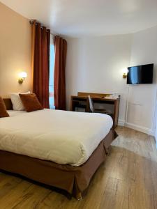 een hotelkamer met een groot bed en een bureau bij Hôtel Du Leman in Parijs