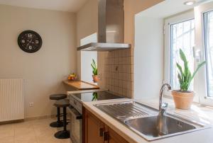 a kitchen with a sink and a stove at Alba Spacious Maisonette in Corfu +23 photos