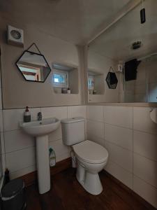 a bathroom with a toilet and a sink at Ty Gwennol near Gilfach Goch in Llanbedr