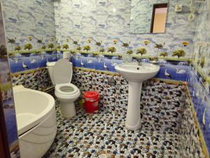 La salle de bains est pourvue de toilettes, d'un lavabo et de toilettes. dans l'établissement B&B Bahodir, à Samarcande