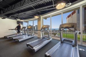 a man walking on treadmill in a gym with windows at Laketown Wharf 1331 in Panama City Beach