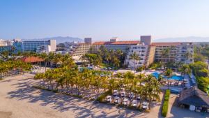 an aerial view of a resort with palm trees and pools at Occidental Nuevo Vallarta in Nuevo Vallarta