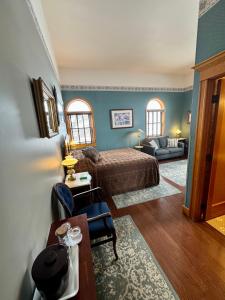 a bedroom with a bed and a living room at Cripple Creek Hospitality House in Cripple Creek