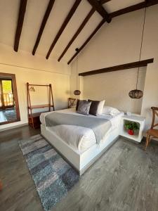 a bedroom with a large bed in a room at Hotel El Embrujo in Villa de Leyva