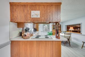 a kitchen with wooden cabinets and a stove top oven at New Holland Apartment with Patio, Deck and Pool in New Holland
