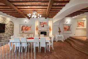 a dining room with a table and chairs and a fireplace at Dimora Il Convento in Scrofiano