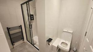 a bathroom with a toilet and a shower at Thames Ditton Surrey in Thames Ditton