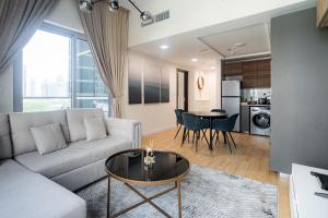 a living room with a couch and a table at Seaside, renewed poshy apartment on JBR in Dubai