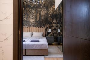 a bedroom with a bed and a wall mural at Seaside, renewed poshy apartment on JBR in Dubai