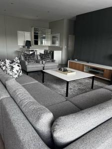 a living room with a couch and a coffee table at Sandton Penthouse Views & Luxury in Johannesburg