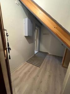 an empty room with a staircase and a stair case at Cozy one-bedroom with a view in Molde