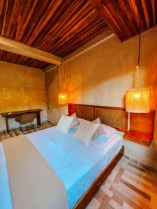 a bedroom with a large bed in a room at Hotel Gavia - Rio y Mar in Palomino