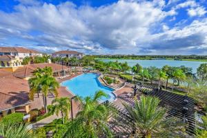 an aerial view of a pool at a resort with a lake at New Modern Townhome, Near The Parks - 4030 in Orlando