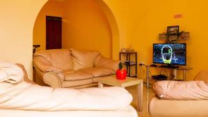 a living room with a couch and a tv at CASA MAYNAS BARRANCO in Lima