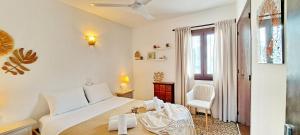 a bedroom with a bed and a chair and a window at Villa Sol in Moraira +30 photos