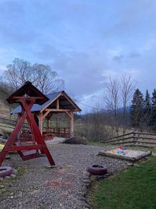a playground with a wooden pavilion and a play set at Шпінь 2 in Vorokhta