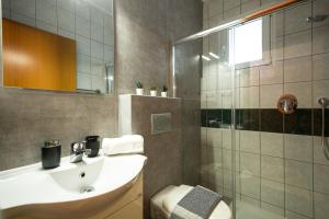 a bathroom with a sink and a shower at Zoe's Place - 1 BD Beachfront Apartment in Kissamos