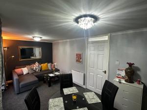 a living room with a couch and a chandelier at Marton Apartments in Marton