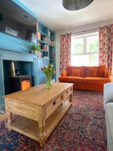 a living room with a couch and a coffee table at Beautiful 3 Bedroom Home, North Cornwall in Saint Teath