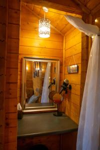 a mirror in a room with a wedding dress in it at Cherry Cabin - Little Log Cabin in Wales in Bettws Cedewain